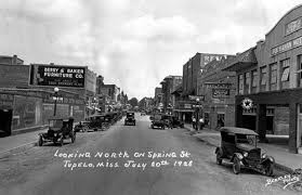 This photo, from a collection in the Lee County Library, shows Spring Street, looking north, as it appeared in 1928. The town was originally named Gum Pond.