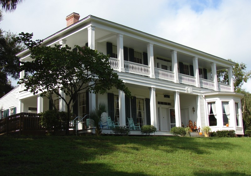 The wide verandas surround two sides of the home on both the first and second stories.