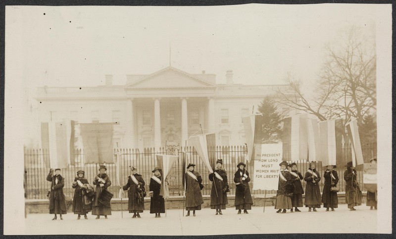 Members of the National Woman's Party stand in front of the White House to make a statement for women's suffrage. Library of Congress.