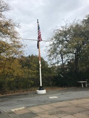 Flagpole behind the sculpture