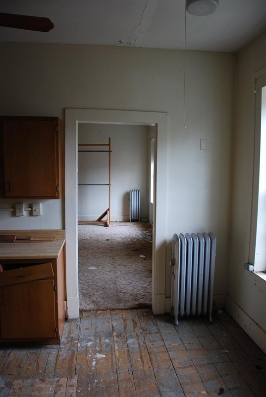 Typical Radiator (source of heat throughout house) and view of original wood flooring.