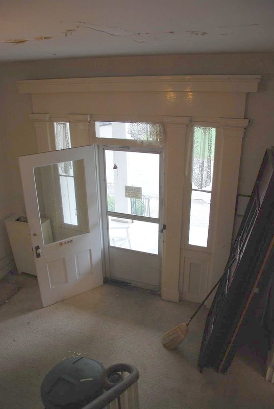 View of Interior Casing, Transom, and Sidelights at First Floor Main Entry.