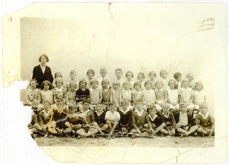 An elementary grade-level class of Armor Park School from 1934-1935. The school, which was administered by the U.S. Navy at the cost of $2.00/year per student, included a full suite of athletic facilities, including baseball and football fields.