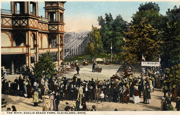 Postcard image (in color) of park-goers waiting in line at the entrance of The Whip, a large entrance structure encompassing the roller coaster tracks (color)