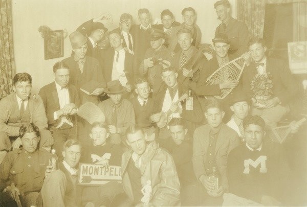 Q.T.V. fraternity during Class of 1928 freshman year, ca. 1923. Members of the QTV fraternity jokingly pose with various props during Horace Brockway's freshman year. "Brockway, Horace '28" and "Freshman year, the boys, QTV fraternity" on back.