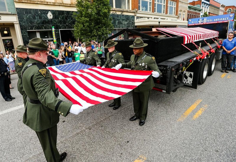 West Virginia State Police Honor Guard fold the colors next to the newly arrived steel beams