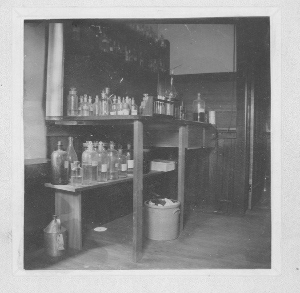 Laboratory bench and chemicals in the Insectary (also known as the Entomological Building), undated. 