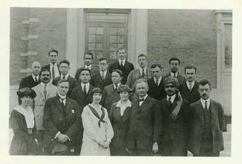 Kenyon L. Butterfield, 1922. Caption of rear of photo says, "College Cosmopolitan Club. 10 nationalities represented. About 1922". Butterfield is in the front row center right. 