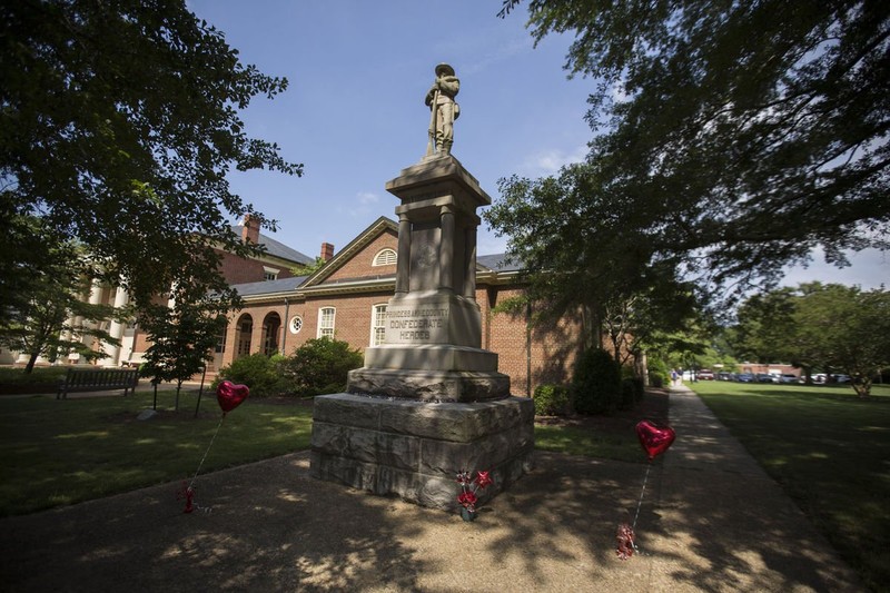 The Confederate Monument standing tall in front of the old courthouse. 