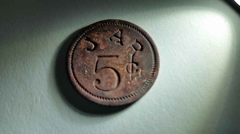 1880s merchant issued 5 cent token uncovered during the Mead's Tavern porch excavation.