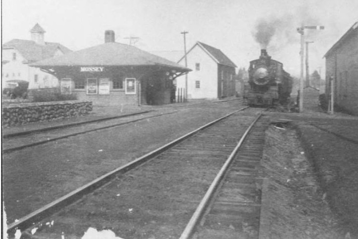 An Engine Roars Past the Tiny Monsey Train Depot