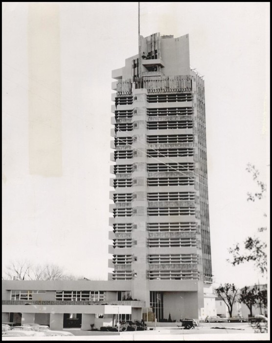 A black and white photo of the Price Tower under construction.