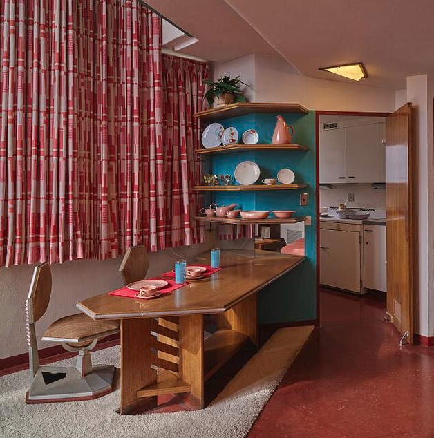 A dining area with mid-century modern furniture.