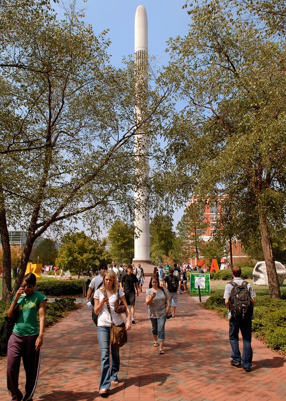 The Belk Bell Tower in September 2007. In front of the tower students walk on a brick path and trees line the path.