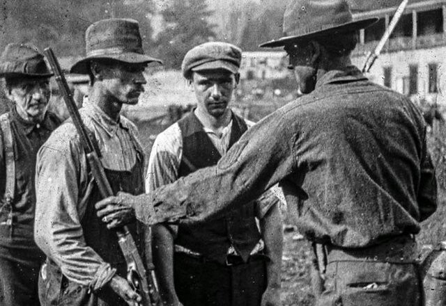 Miners surrender their rifles after Battle of Blair Mountain, 1921.