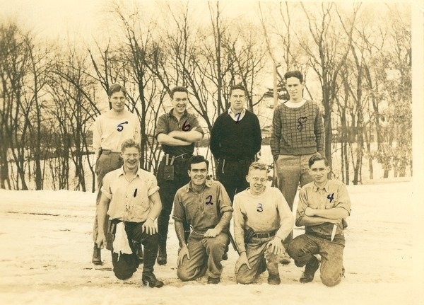 Fraternity men posing outdoors in the winter, ca. 1938. Class of 1939 members from various fraternities pose near the campus pond in the winter, including #6, (top row, 2nd from left), Phi Sigma Kappa member Emerson Wallace Grant.