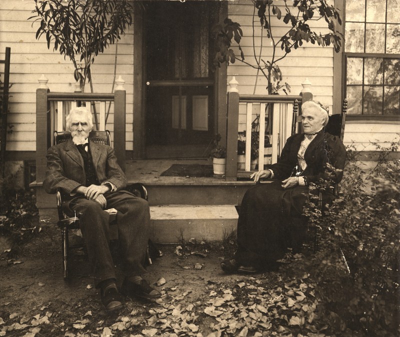 Levi and Millie Booth sitting outside of the house, ca. 1904.