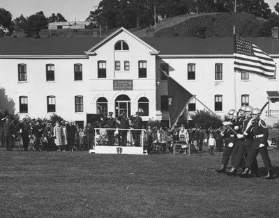 The Sixth ARADCOM Headquarters building in the background with a military parade for visiting military dignitaries in the foreground.