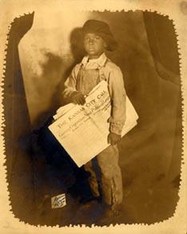 Photograph of a unidentified newsboy holding the Kansas City Call.