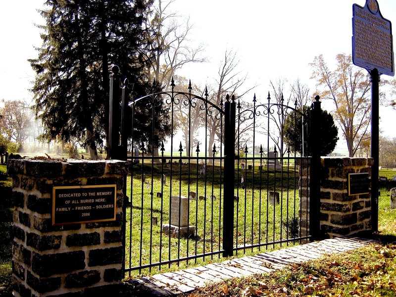 Entrance gate to the cemetery along with plaque remembering all who have been laid to rest 