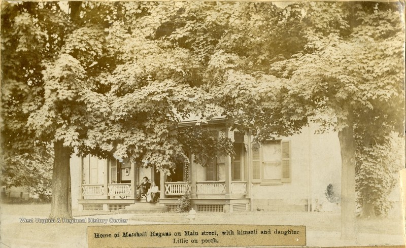 Hagans sitting on a front porch with his granddaughter Lillie. Photo taken at Hagan's home on High Street in Morgantown, ca. 1890.