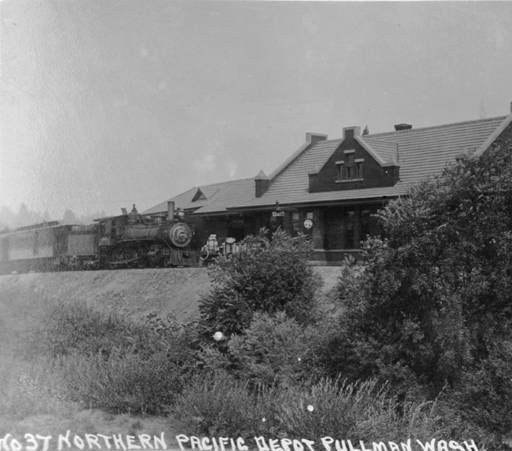 A train pulled to a stop in front of the depot, taken ca. 1920 by Artopho Studio. Courtesy WSU Special Collections. http://content.libraries.wsu.edu/cdm/compoundobject/collection/pullman/id/1131/show/23/rec/1