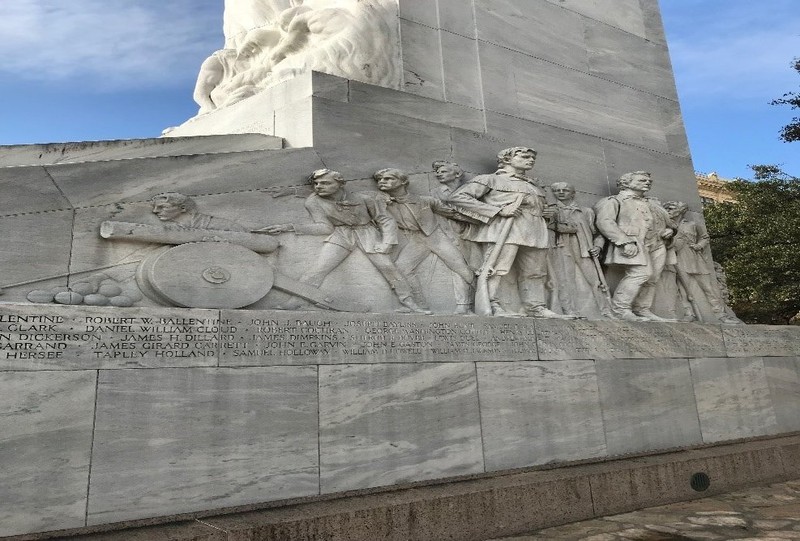 Side angle view of Bonham, Bowie, the eight soldiers, and the inscribed names of the deceased soldiers.