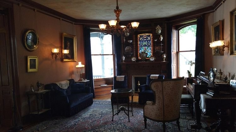 The home's drawing room with its cherry mantle around its jeweled-glass window which is used to display some of the museum's treasures.  