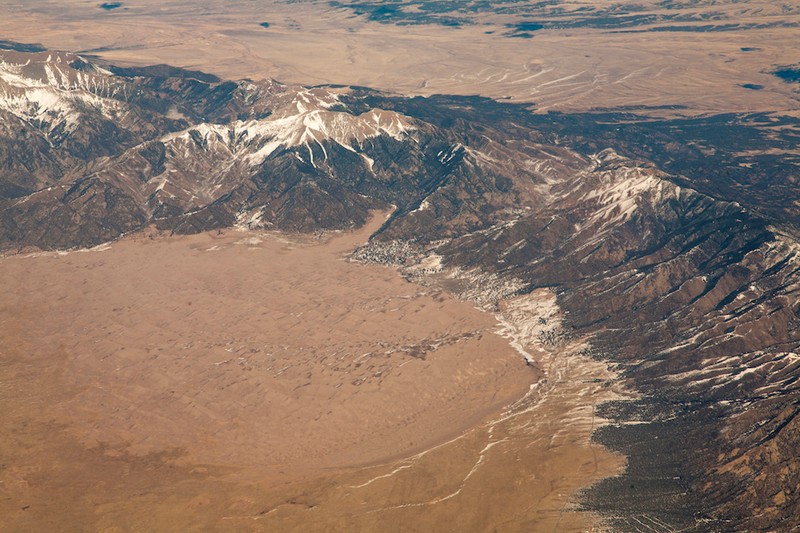 Aerial view of the dunes and the Sangre de Cristo Range. The visitor center is not visible but is located on the bottom right of the photo.