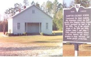 Image of the front of the building where you pull in, as well as the marker in front of the building by the road