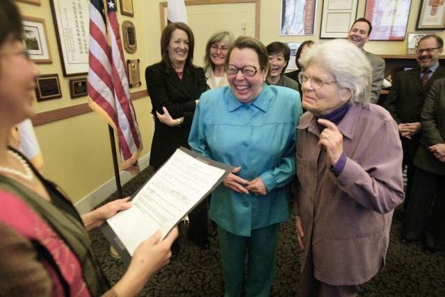 Phyllis Lyon (left) and Del Martin (right) receiving the first marriage license for a same-sex couple in the state of California.