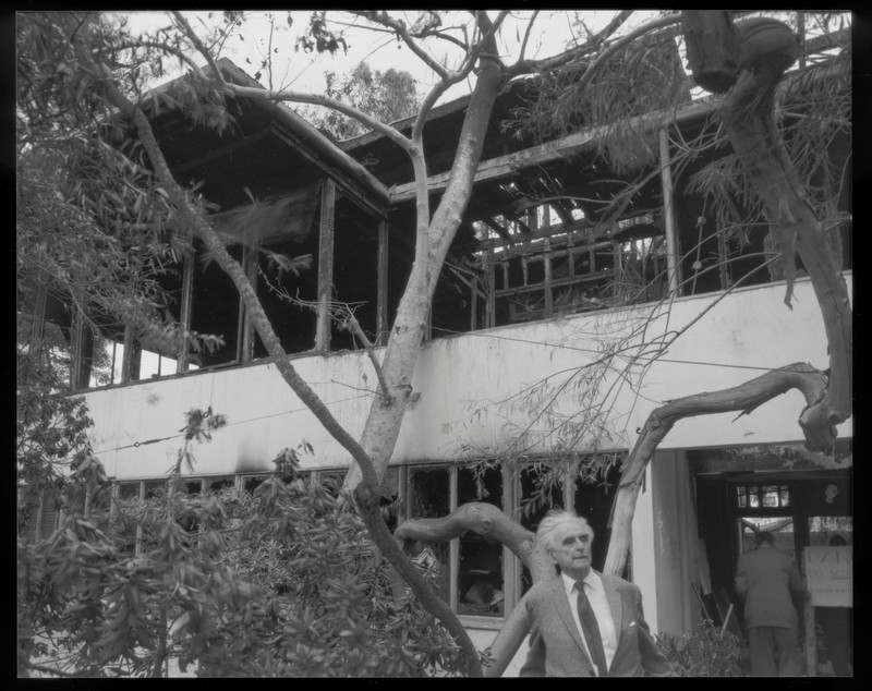 Richard Neutra standing outside his cherished home shortly after the 1963 fire.