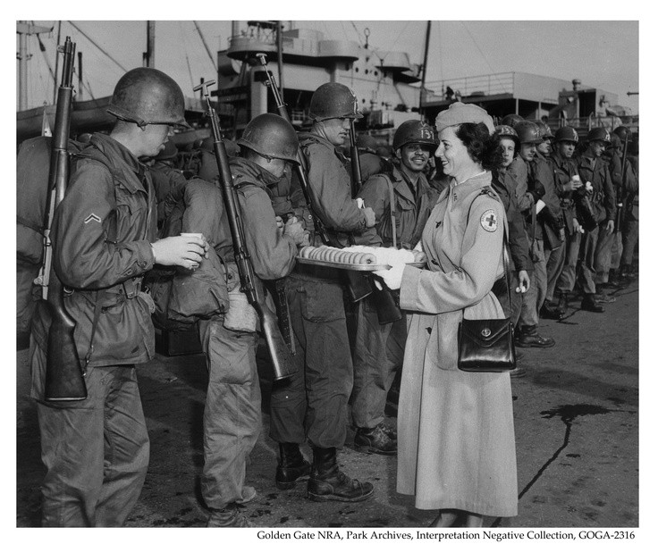 Soldiers being fed cookies and coffee by the American Red Cross 