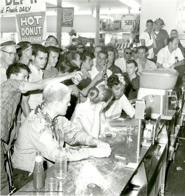 This iconic image of the Jackson Woolworth sit-in has come to symbolize the modern civil rights movement. At left sits John R. Salter, Jr. (a Native American who would change his name to Hunter Gray), Joan Trumpauer (later Joan Mulholland) one of two whit