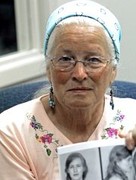 Joan Trumpauer Mulholland holds a photo of her mugshot prior to a commemoration of the sit-in in 2009