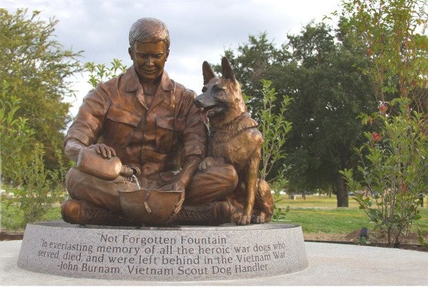 Photo dedicated to all dogs that served in the military; photo taken is of veteran John Burnam with one of his service dogs during the Vietnam War. (Known as the Not Forgotten Fountain)