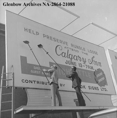 Supporters of the preservation of Rundle Lodge erect a billboard to support the fundraiser starring Rich Little to preserve the building, May 1972