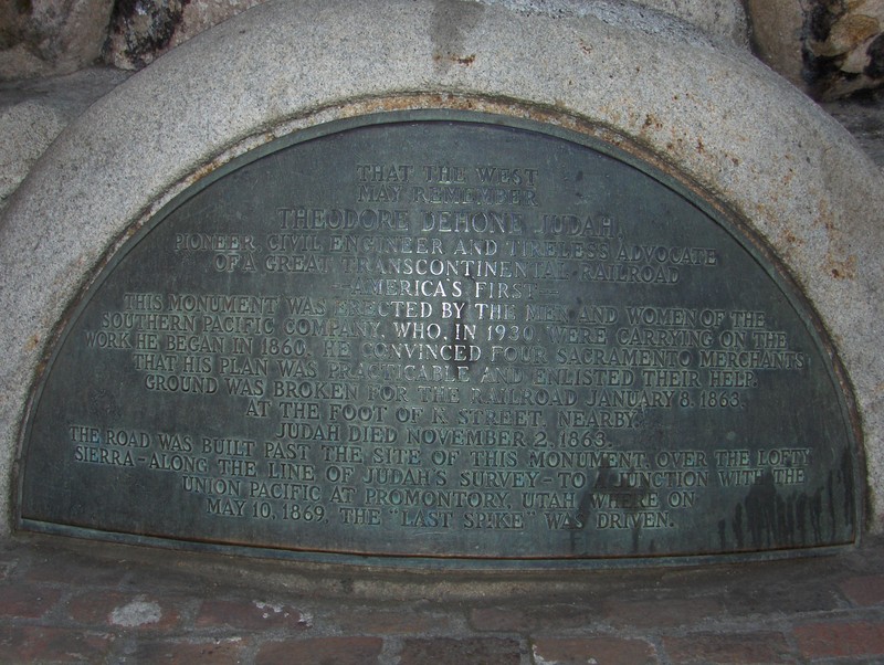 The inscription at the base of the monument commemorates Judah's pivotal role in the Transcontinental Railroad's creation, "that the west may remember."