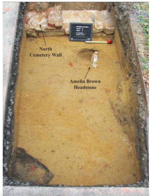 Photograph of the unearthing of Amelia Brown's headstone in 2013