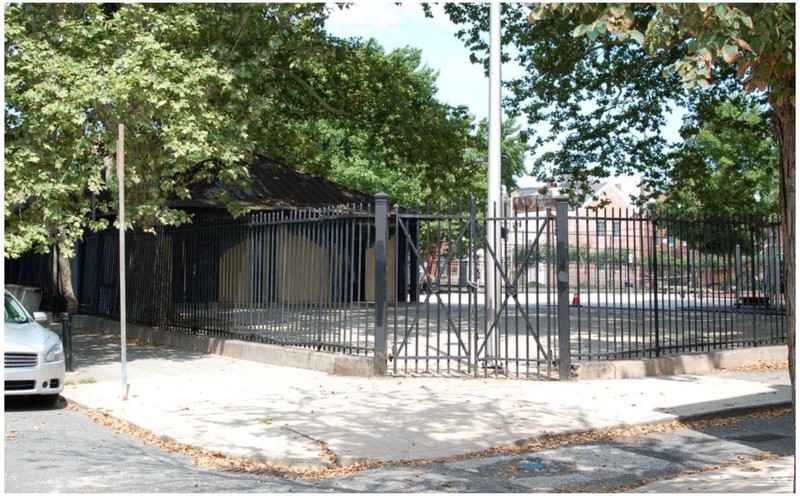 Photo of the southeastern limits of the burial ground, with rec building and tennis court visible. The tennis court and rec building cover the burial ground almost completely.
