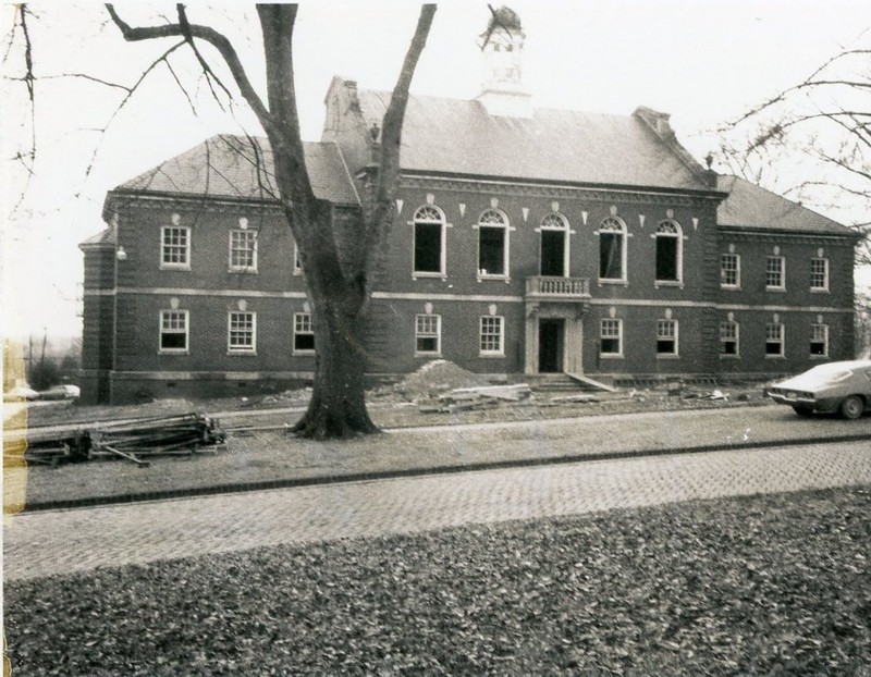 Black and White photo of the front of Calkins Hall during a renovation. 