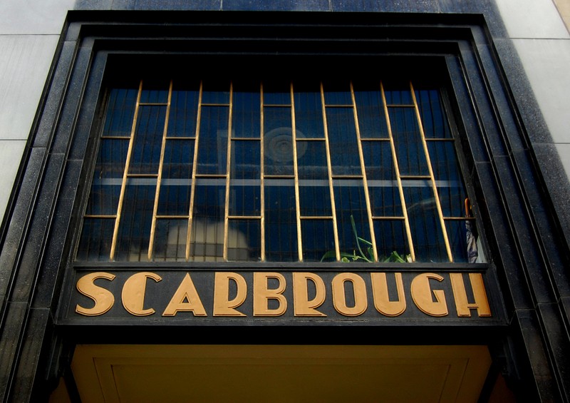 The golden letters of the Scarbrough Building's sign