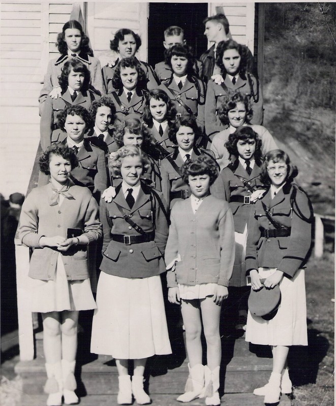 High school band standing on the steps of the church.