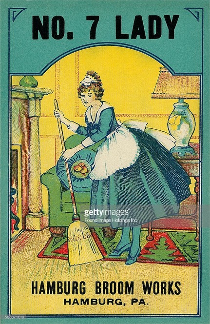 A vintage advertisement for Hamburg Broom Works featuring a maid in a green dress, sweeping the floor with a straw broom, 1920