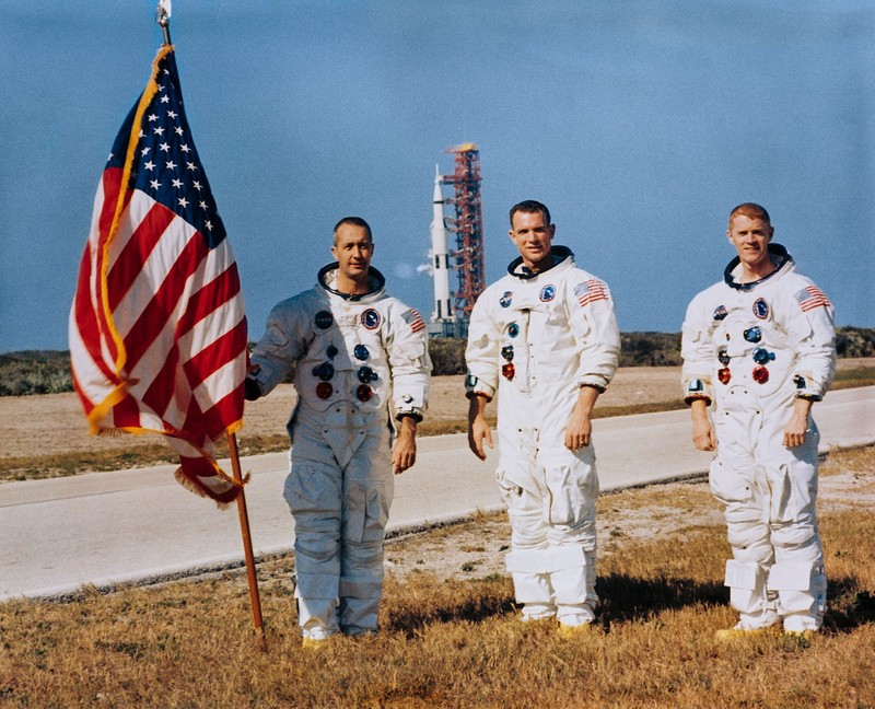 Apollo 9's James McDivitt, David Scott, and Russell Schweickart prepare for their launch. Behind them is Apollo 8's Saturn V on Launch Pad 39A. Courtesy of NASA.