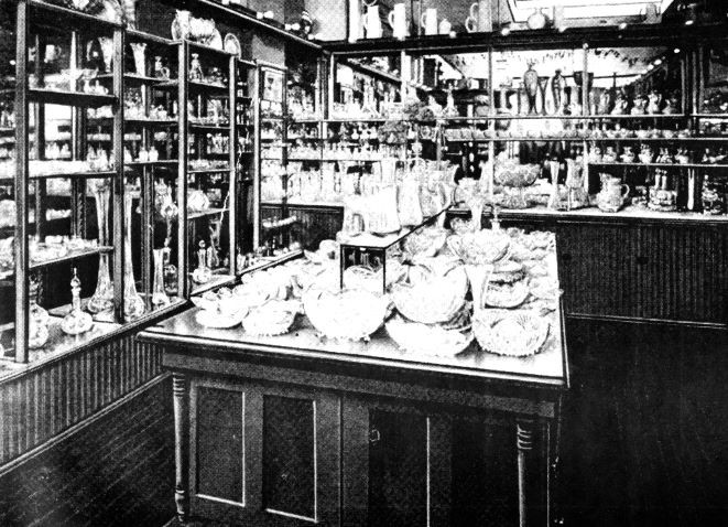A black and white photo, which is a view of a large inventory of cut glass items.
