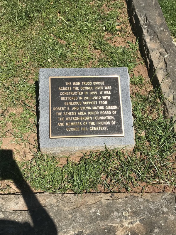 Marker describing the Iron Truss bridge that connects the older section of the cemetery to the newer