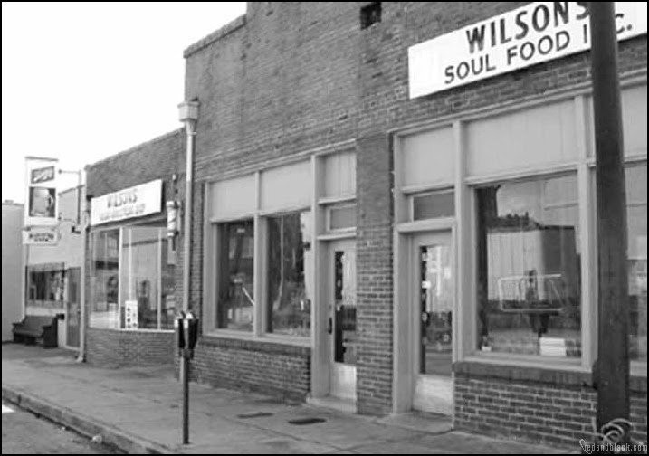 Black-owned businesses have thrived at Hot Corner since the 1950s. Featured above is M.C. Wilson's styling shop and restaurant, circa 1981.