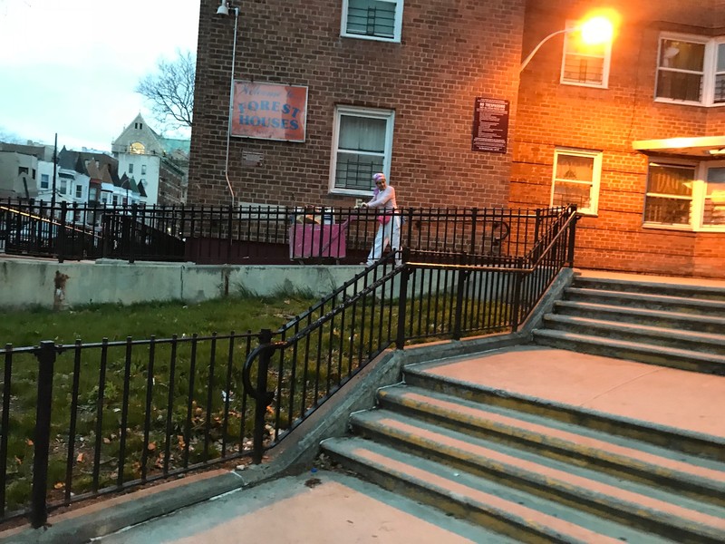 An elderly woman pushing a cart down a ramp at Forest Houses (Picture taken by Matthew Martinez)