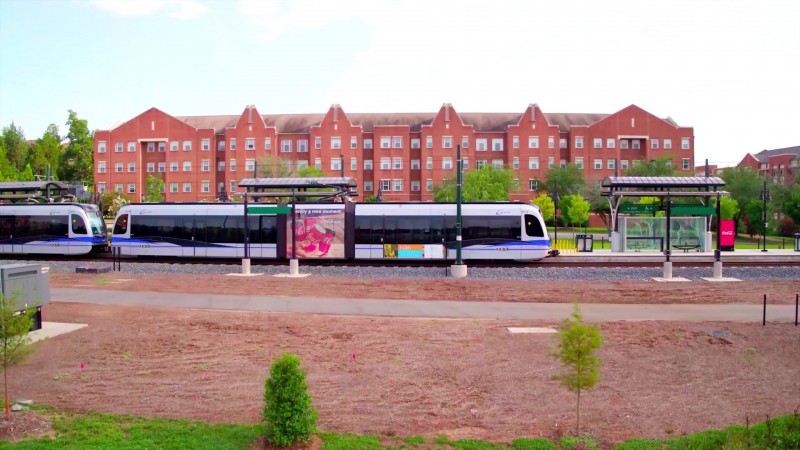 University Communications photograph of UNC Charlotte Main Station with Wallis Hall in the background. Photograph is a still from a video showing an aerial view of the station.